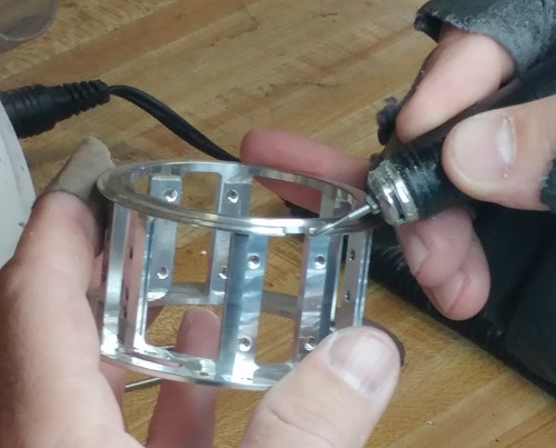 Picture of an employee deburring a part